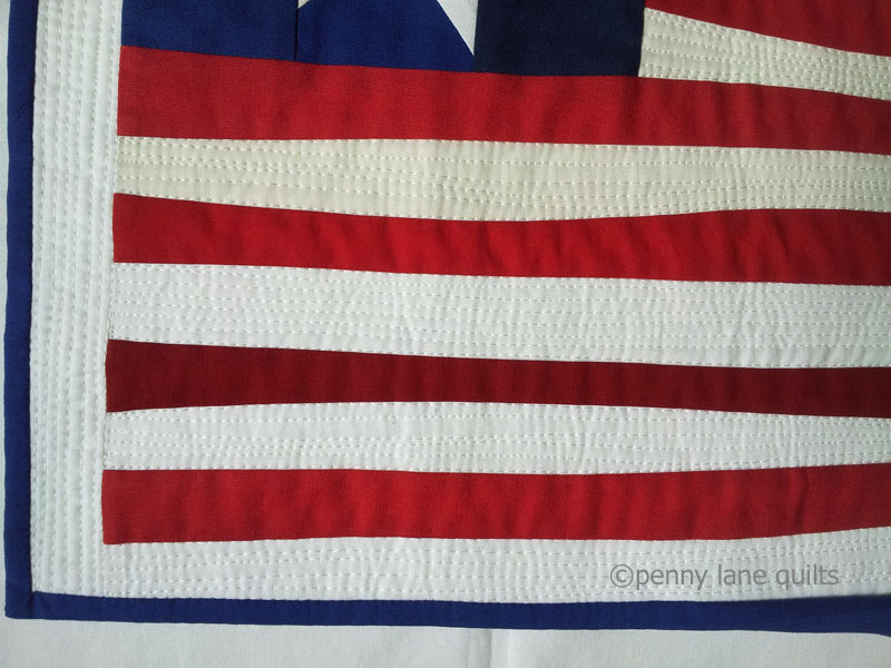dense machine quilting on the stripes of "Made in America" , Marla Varner, penny lane quilts
