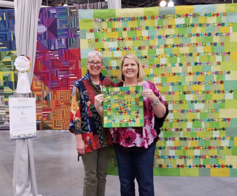 Sandra Kaye with her two versions of Happy Dance, QuiltCon 2018 Pasadena